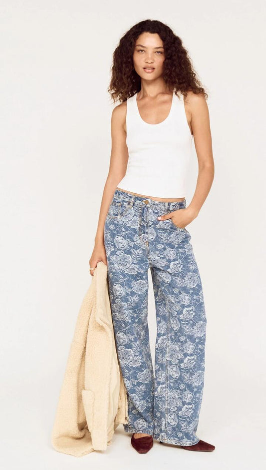 Image of a model wearing Pants. Product name - Mid Rise Floral Denim Wide Leg Jeans in Mid Indigo Wash colour by brand - MINKPINK