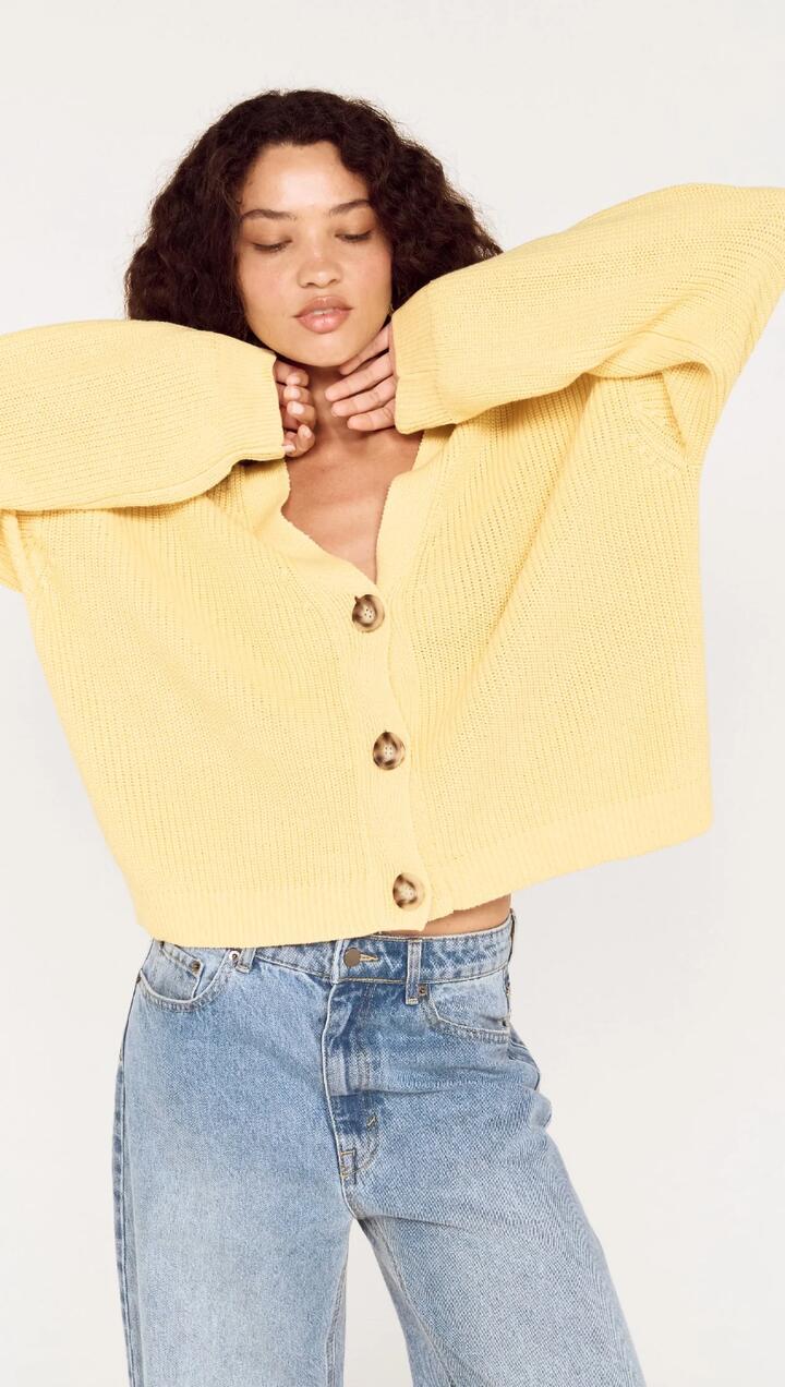 Image of a model wearing Outerwear. Product name - Butter Yellow Oversized Cardigan with Volume Sleeve in Daffodil colour by brand - MINKPINK