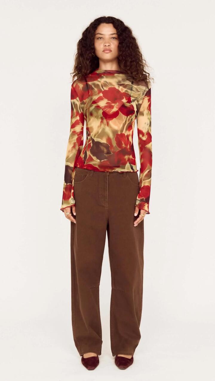 Image of a model wearing Pants. Product name - Brown Mid Rise Barrel Leg Jeans in Chocolate colour by brand - MINKPINK