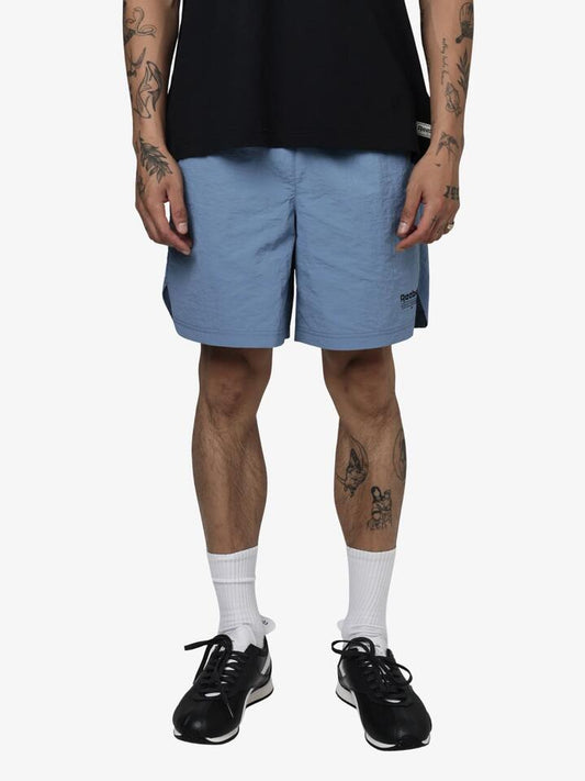 Image of a model wearing Shorts. Productname: Reebok Premier Running Club Woven Shorts in Hazy Blue colour by brand - Reebok