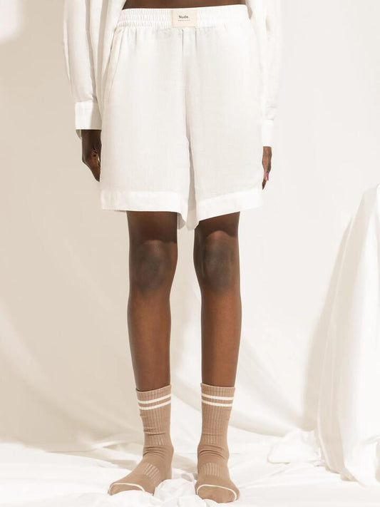 Image of a model wearing Shorts. Productname: Nude Lucy Lounge Heritage Linen Shorts in White colour by brand - Nude Lucy