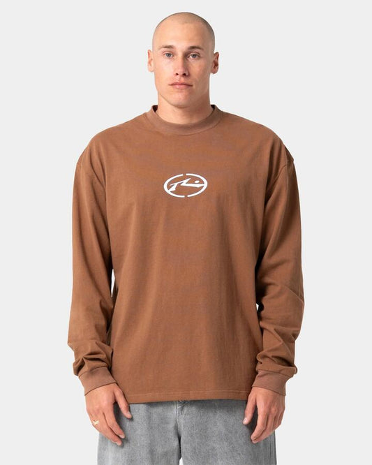 Image of a model wearing Tops. Product name - Rusty Mens Turbo Long Sleeve T-Shirt Pinecone in Pinecone colour by brand - Rusty