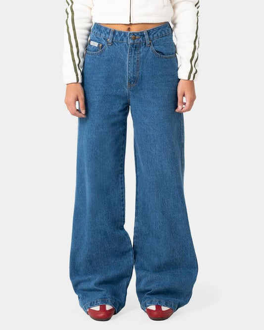 Image of a model wearing Pants. Product name - Rusty Womens Cyprus Wide Leg High Waist Denim Jeans Authentic Blue in Authentic Blue colour by brand - Rusty