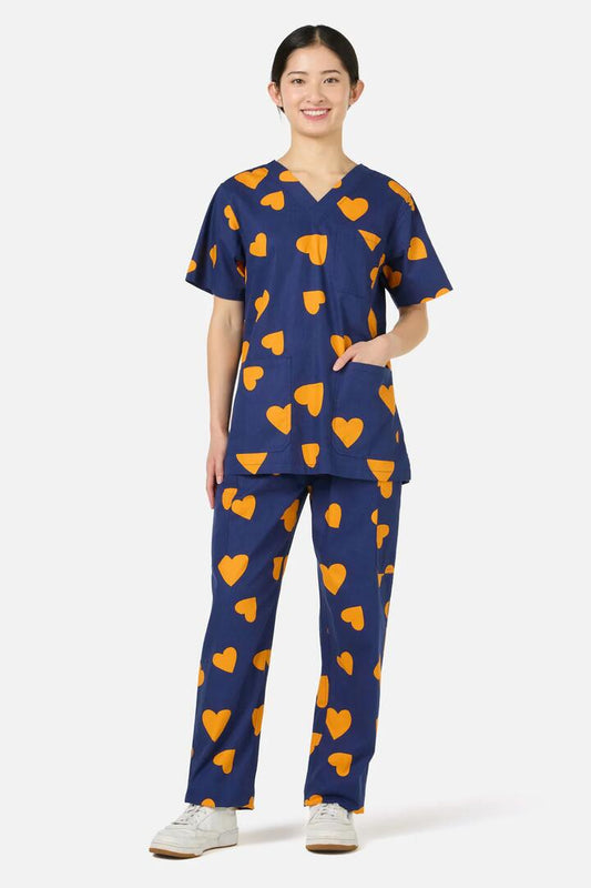 Image of a model wearing Uniforms & Workwear. Productname: Orange Hearts Scrub Set in Navy colour by brand - Scrubs With Love