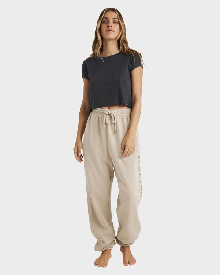 Image of a model wearing Pants. Product name - Billabong Womens Baseline Track Pants Coyote in Coyote colour by brand - Billabong