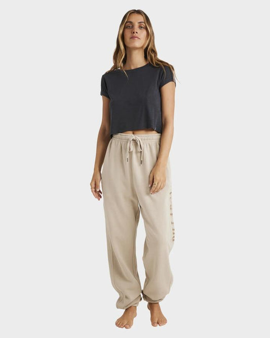Image of a model wearing Pants. Product name - Billabong Womens Baseline Track Pants Coyote in Coyote colour by brand - Billabong