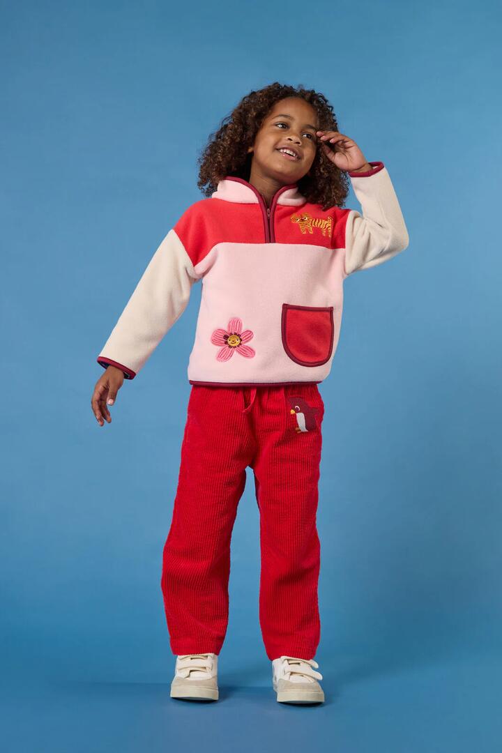 Image of a model wearing Pants. Product name - Penguin Cord Kids Pant in Red colour by brand - Gorman