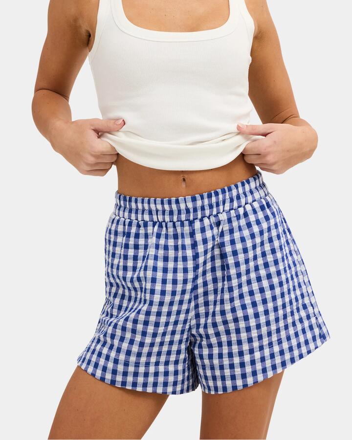 Image of a model wearing Shorts. Product name - Nunui Womens Venice Check Elastic Waist Shorts Blue in Blue colour by brand - Nunui