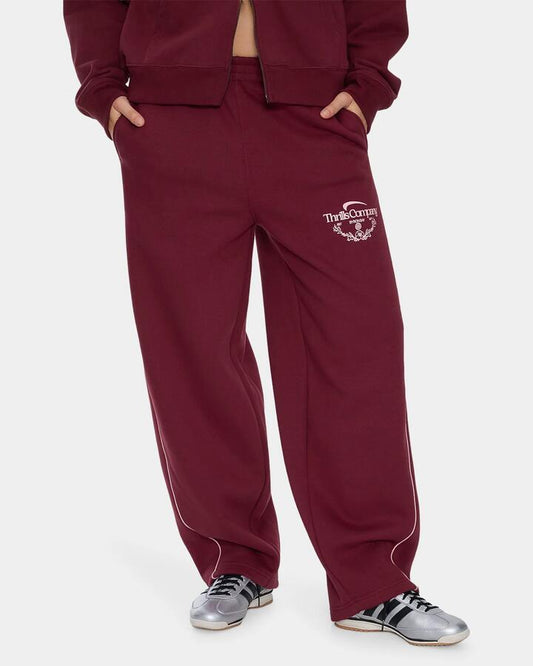 Image of a model wearing Pants. Product name - Thrills Womens End Game Track Pants New Maroon in New Maroon colour by brand - Thrills