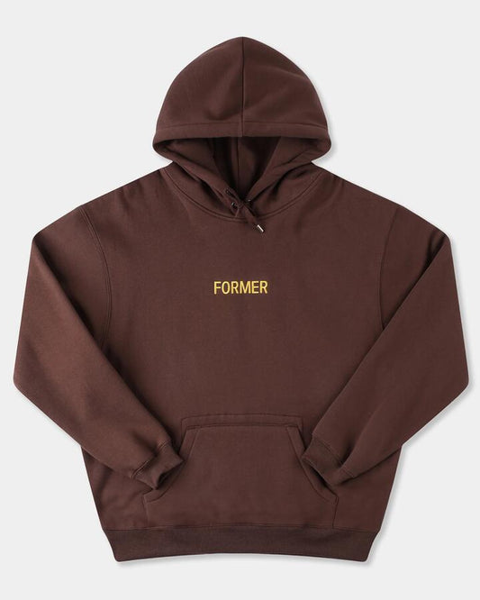 Image of a model wearing Outerwear. Product name - Former Mens Legacy Embrodery Pullover Hoodie Brown in Brown colour by brand - Former