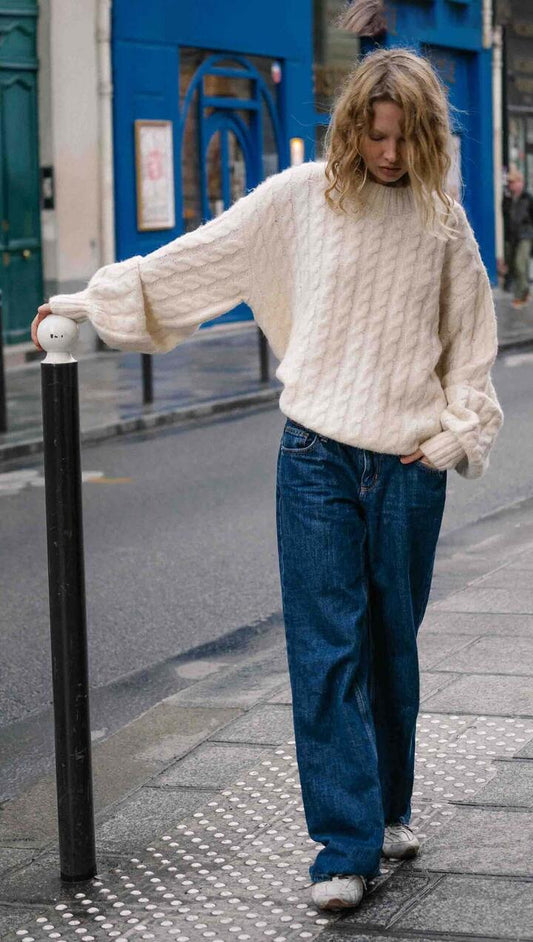 Image of a model wearing Outerwear. Product name - Cream Relaxed Fit Cable Knit Jumper in Warm White colour by brand - MINKPINK