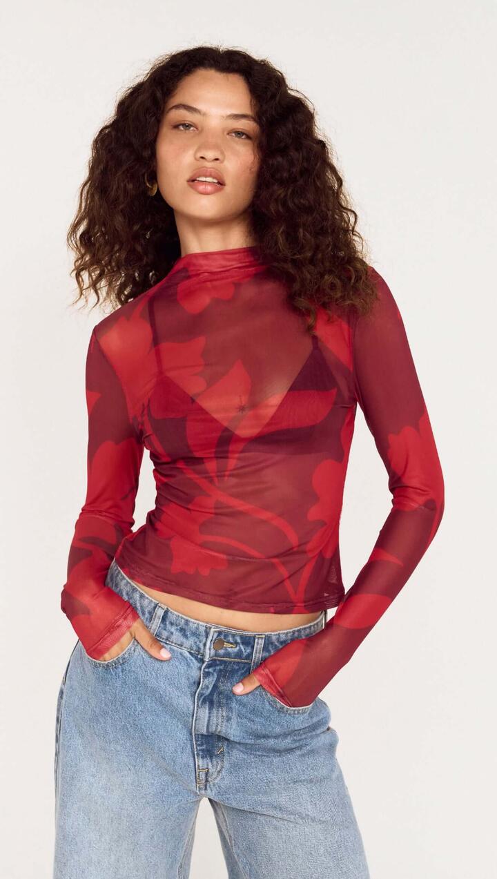 Image of a model wearing Tops. Product name - Oversized Floral High Neck Mesh Top in Wine Shadow Floral colour by brand - MINKPINK