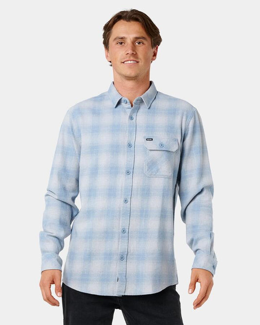 Image of a model wearing Tops. Product name - Rip Curl Mens Grinners Flannel Long Sleeve Shirt Faded Denim in Faded Denim colour by brand - Rip Curl