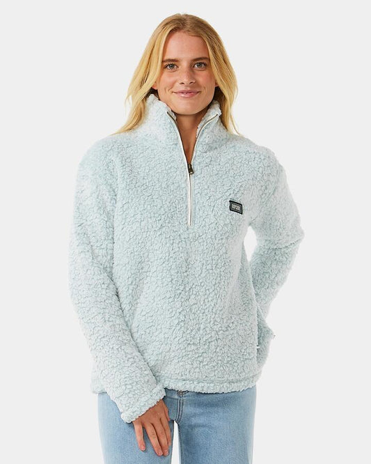 Image of a model wearing Outerwear. Product name - Rip Curl Womens Dark N Stormy 1/4 Zip Fleece Jumper Blue in Blue colour by brand - Rip Curl