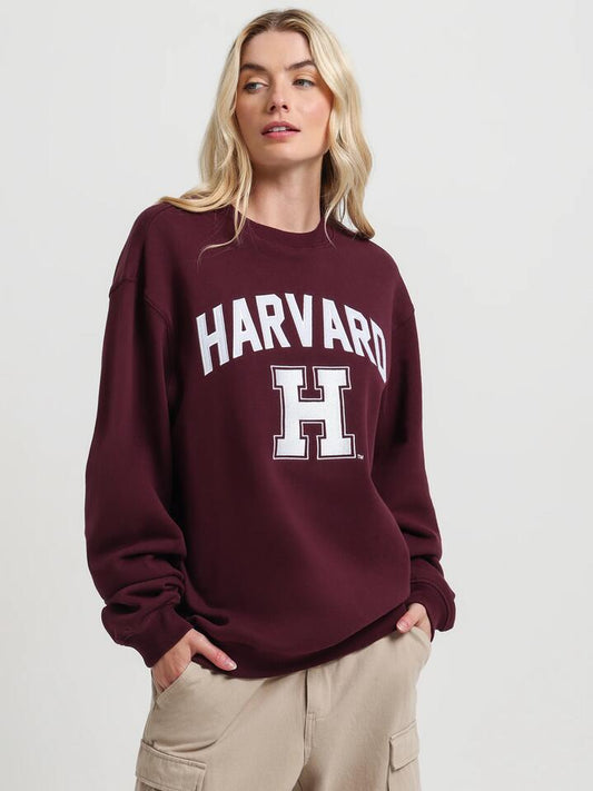 Image of a model wearing Outerwear. Productname: Ncaa Harvard University Crew Fleece in Wine colour by brand - Ncaa