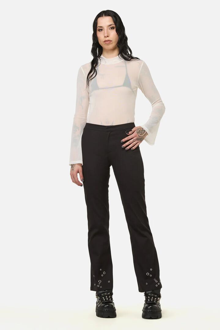 Image of a model wearing Pants. Productname: Enamored Eyelet Goth Pant in Black colour by brand - Black Friday
