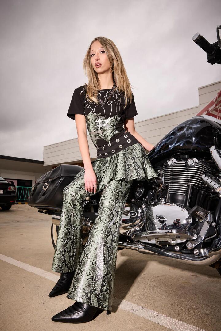 Image of a model wearing Skirts. Productname: Y2K Snakey Eyelet Mini Skort in Grey/Black colour by brand - Dangerfield