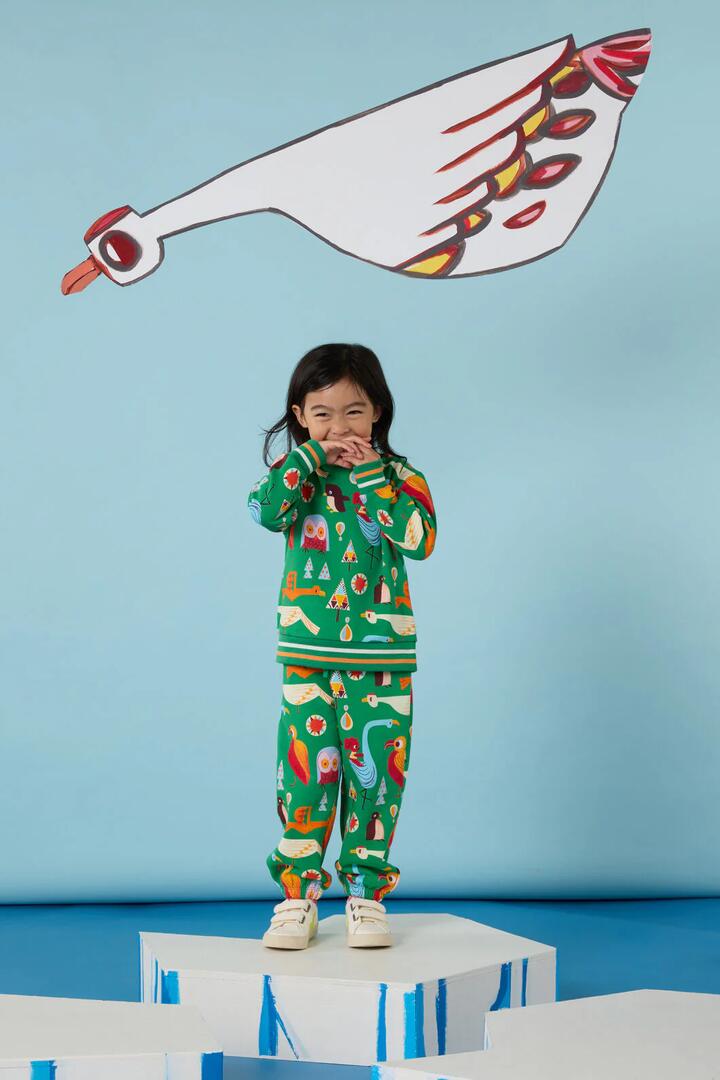 Image of a model wearing Pants. Product name - Funky Birds Kids Track Pant in Green colour by brand - Gorman