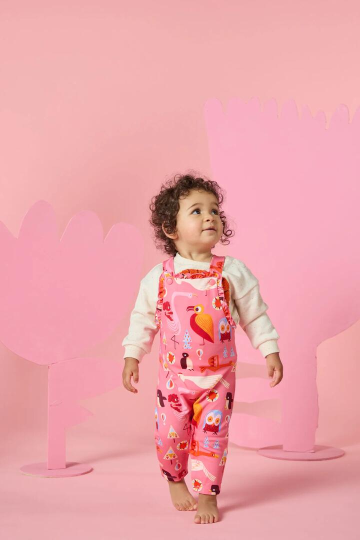 Image of a model wearing Pants. Product name - Funky Birds Baby Overalls in Pink colour by brand - Gorman