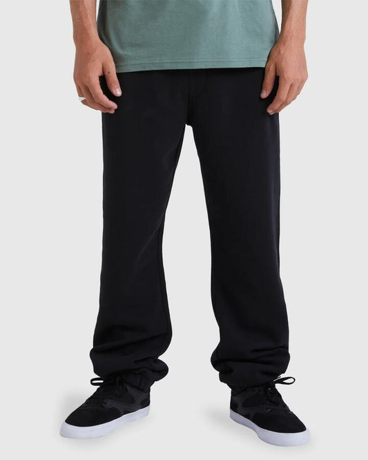 Image of a model wearing Pants. Product name - Quiksilver Mens Ocean Spray Track Pants Black in Black colour by brand - Quiksilver