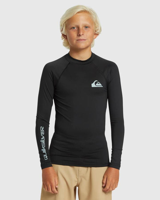 Image of a model wearing Tops. Product name - Quiksilver Boys 8-16 Everyday Solid Long Sleeve Upf 50 Rash Vest Black in Black colour by brand - Quiksilver
