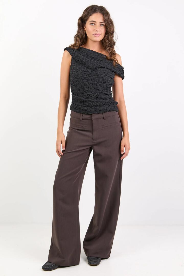 Image of a model wearing Pants. Product name - Fierce Chocolate Mid Rise Stretch Wide Pants in Chocolate colour by brand - Stories be Told