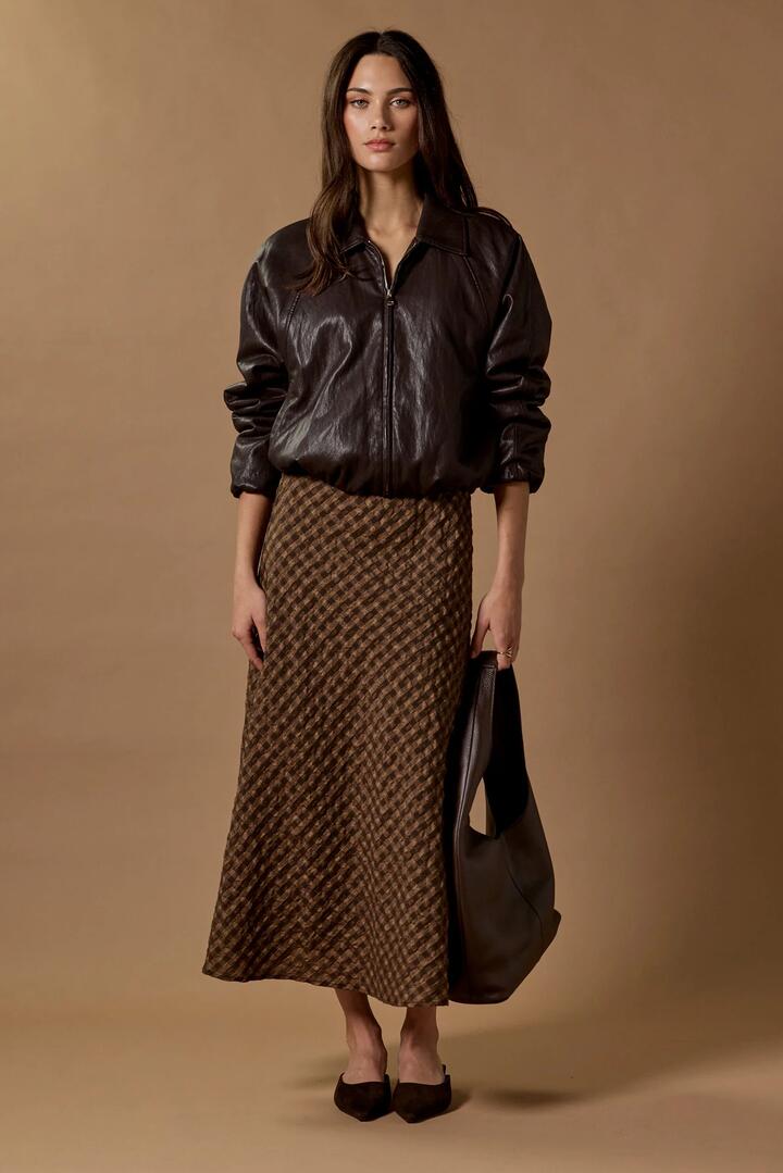 Image of a model wearing Skirts. Product name - Companion Chocolate Caramel Check Cotton Blend Bias Maxi Skirt in Chocolate Caramel Check colour by brand - Stories be Told