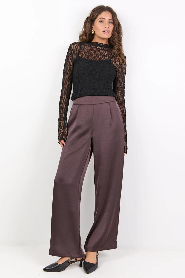 Image of a model wearing Pants. Product name - Grandeur Chocolate Satin Elastic Back Wide Leg Pants in Chocolate Satin colour by brand - By Rosa.
