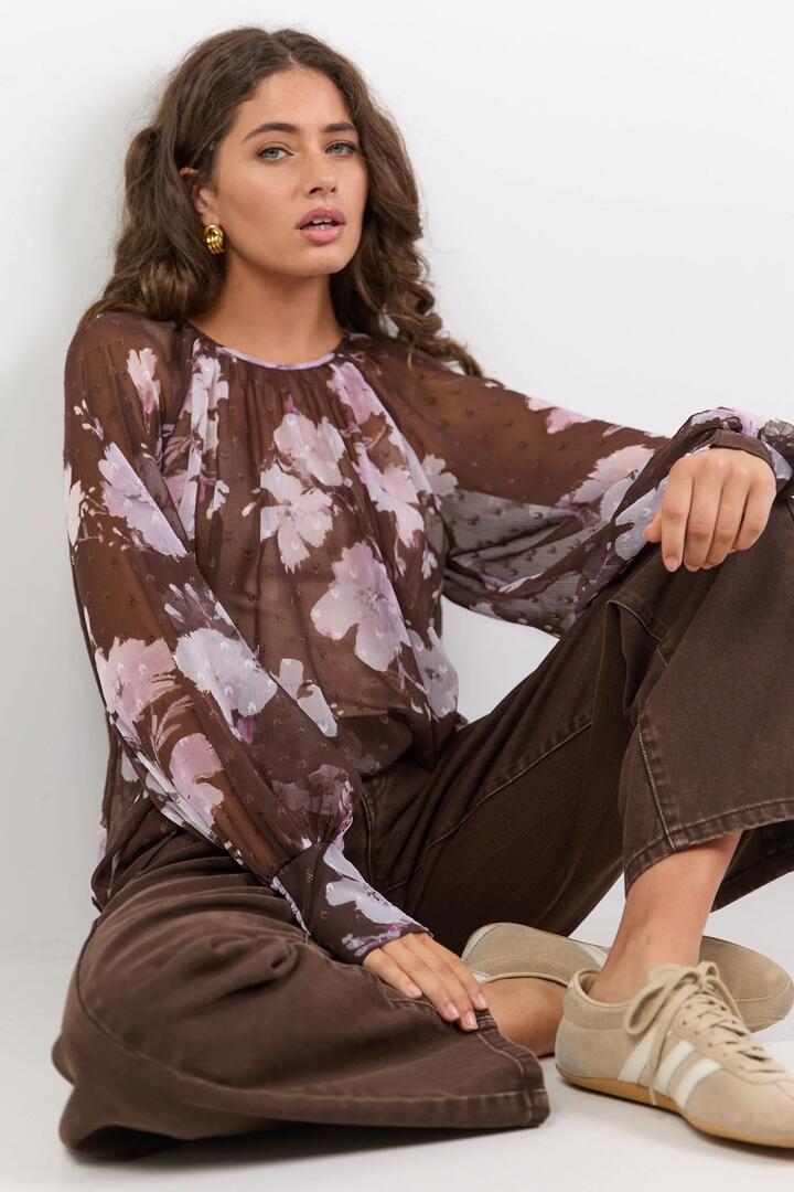 Image of a model wearing Tops. Product name - Cosmopolitan Cocoa Blossom Crew Neck Long Sleeve Top in Cocoa Blossom colour by brand - Stories be Told