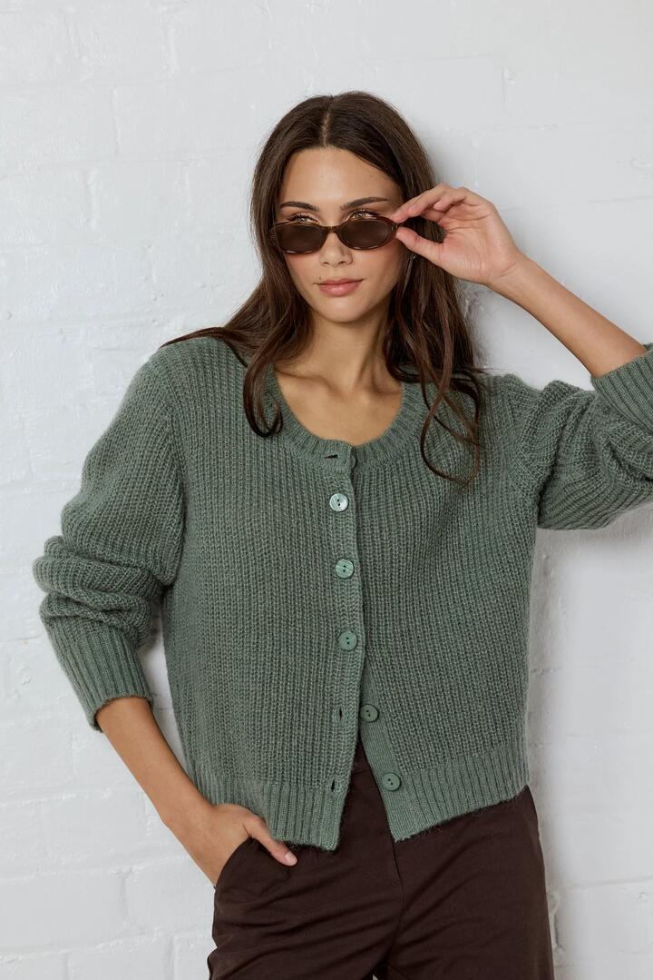 Image of a model wearing Outerwear. Product name - Highlight Sage Mohair Blend Crewneck Cardigan in Sage colour by brand - Ivy + Jack