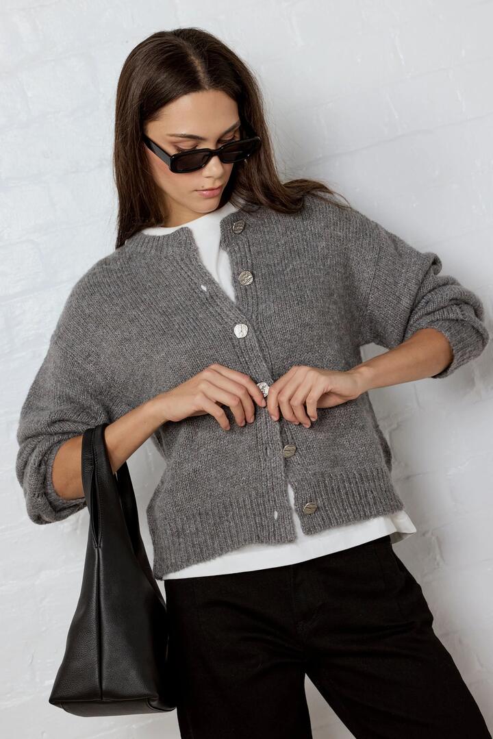 Image of a model wearing Outerwear. Product name - Mirage Grey Marle Fluffy Crewneck Cardigan in Grey Marle colour by brand - Among the Brave