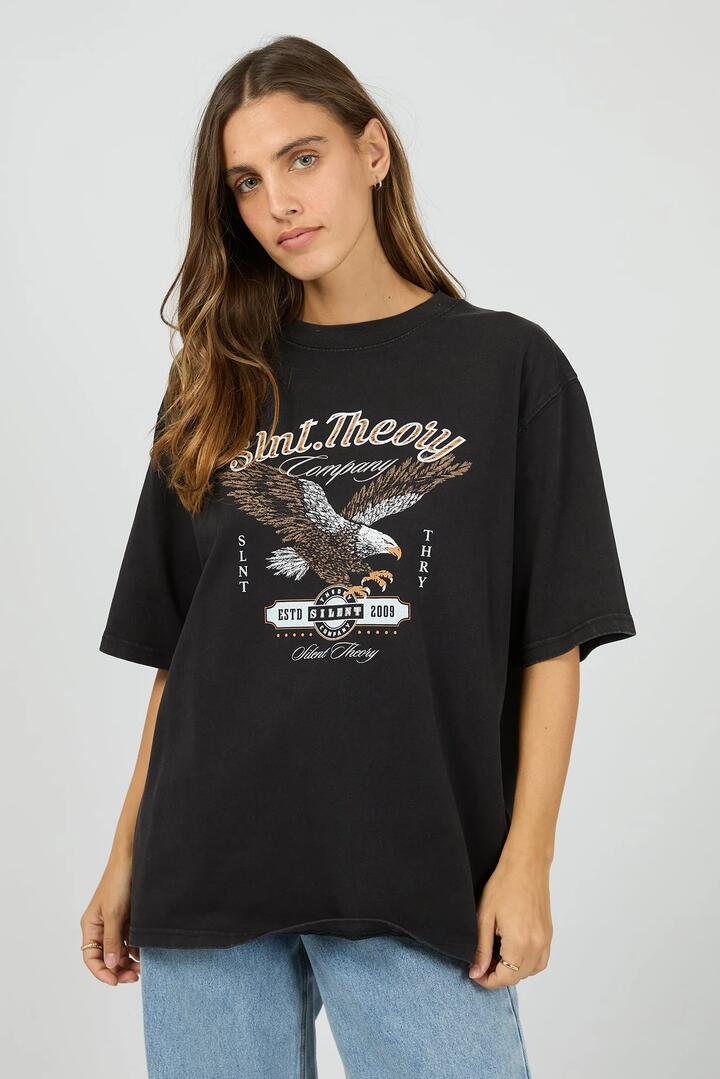 Image of a model wearing Tops. Product name - Legacy Washed Black Eagle Graphic Tee in Black colour by brand - Silent Theory