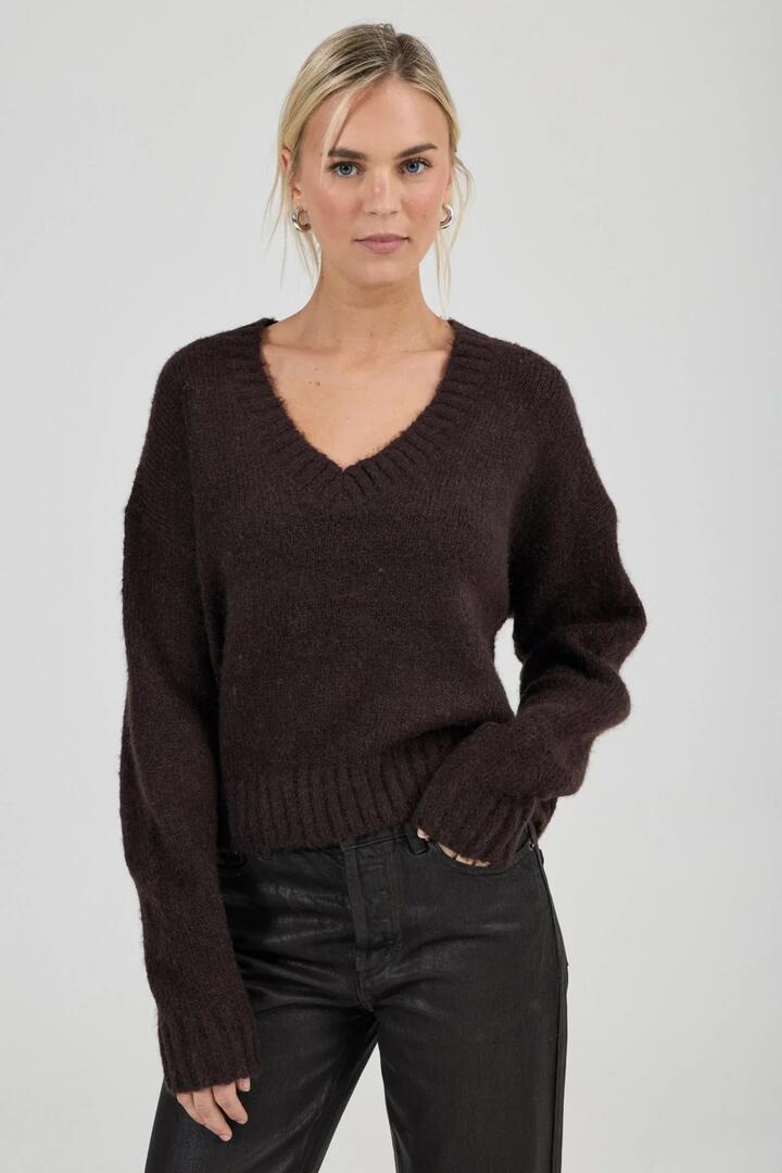 Image of a model wearing Outerwear. Product name - Tomboy Espresso V Neck Knit in Brown colour by brand - Rollas