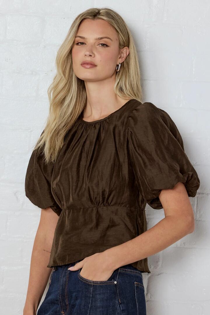 Image of a model wearing Tops. Product name - Finali Chocolate Puff Short Sleeve Top in Chocolate colour by brand - Stories be Told