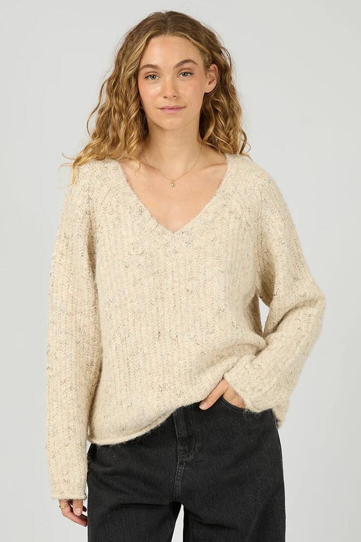 Image of a model wearing Outerwear. Product name - Devon Vanilla V Neck Jumper in Cream colour by brand - All About Eve