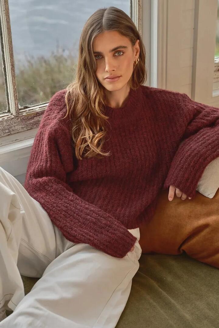 Image of a model wearing Outerwear. Product name - Ivy Wine Knit Jumper in Red colour by brand - All About Eve