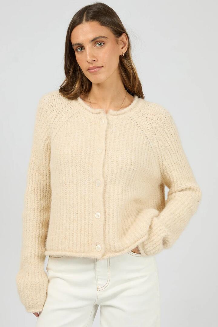 Image of a model wearing Outerwear. Product name - Devon Cream Crew Cardigan in Cream colour by brand - All About Eve