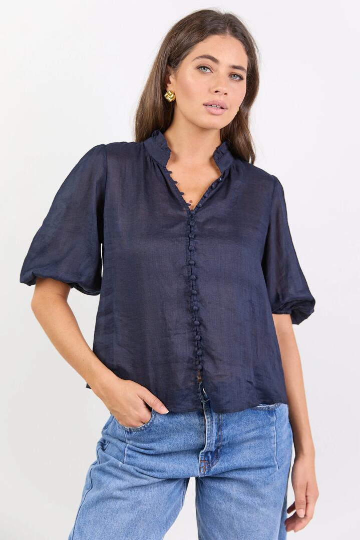 Image of a model wearing Tops. Product name - Continuance Navy Ramie High Neck Buttoned SS Top in Navy colour by brand - Ivy + Jack