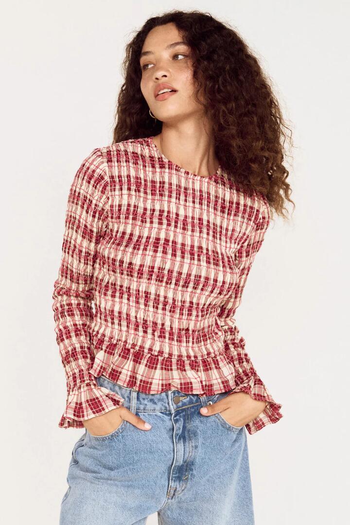 Image of a model wearing Tops. Product name - Anouk Wine Check Shirred LS Top in Red colour by brand - Mink Pink
