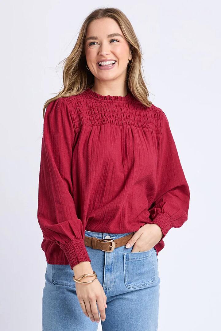 Image of a model wearing Tops. Product name - Whitney Rhubarb Red Shirred LS Top in Red colour by brand - Foxwood