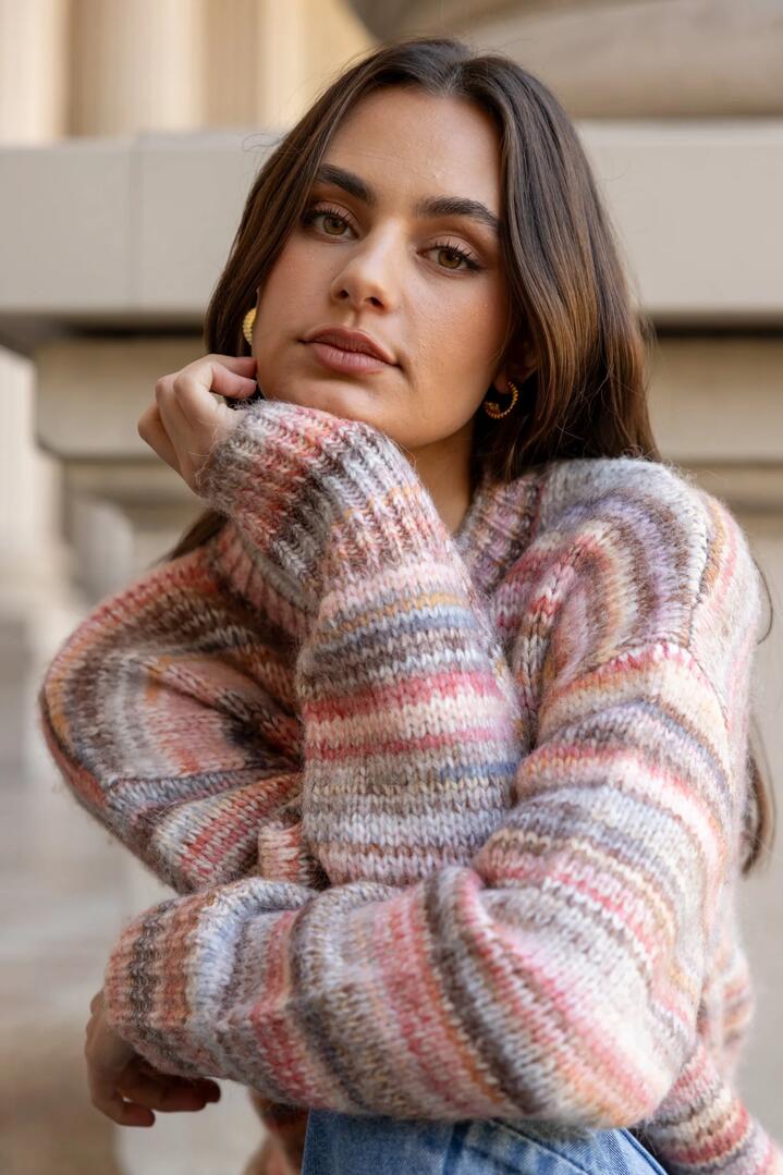 Image of a model wearing Outerwear. Product name - Arbitrary Rose Multi Space Dye Crewneck Jumper in Rose Multi colour by brand - Among the Brave