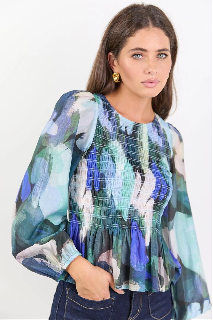Image of a model wearing Tops. Product name - Assent Blue Abstract Print Shirred Long Sleeve Top in Blue Abstract Print colour by brand - Among the Brave
