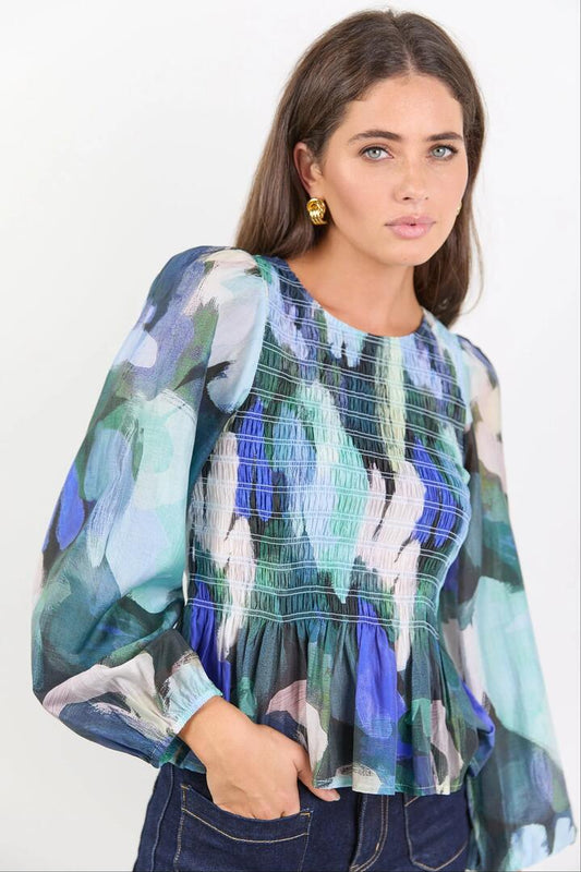 Image of a model wearing Tops. Product name - Assent Blue Abstract Print Shirred Long Sleeve Top in Blue Abstract Print colour by brand - Among the Brave
