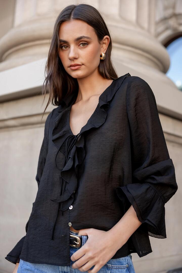 Image of a model wearing Tops. Product name - Bohemian Black Sheer Frill Front Blouse in Black colour by brand - Among the Brave
