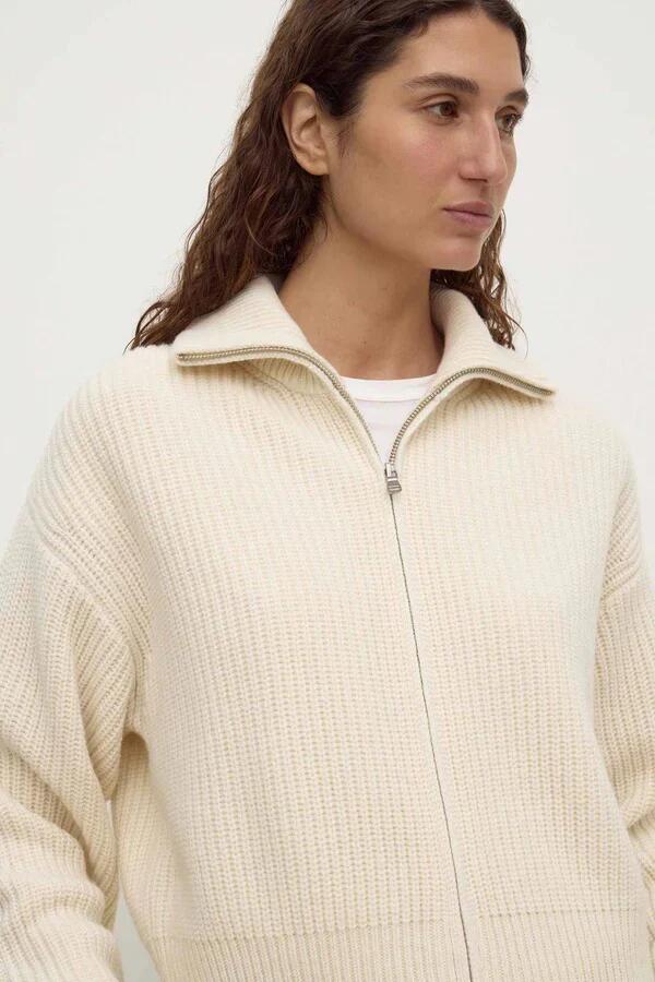 Image of a model wearing Outerwear. Product name - Kaia Antique White Wool Zip Sweater in Cream colour by brand - Assembly Label
