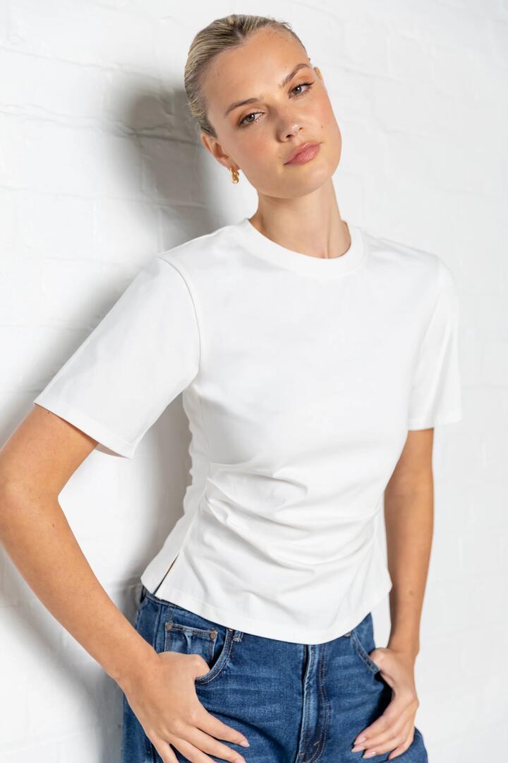 Image of a model wearing Tops. Product name - Syllabus White Cotton Pintuck SS Tee in White colour by brand - By Rosa.