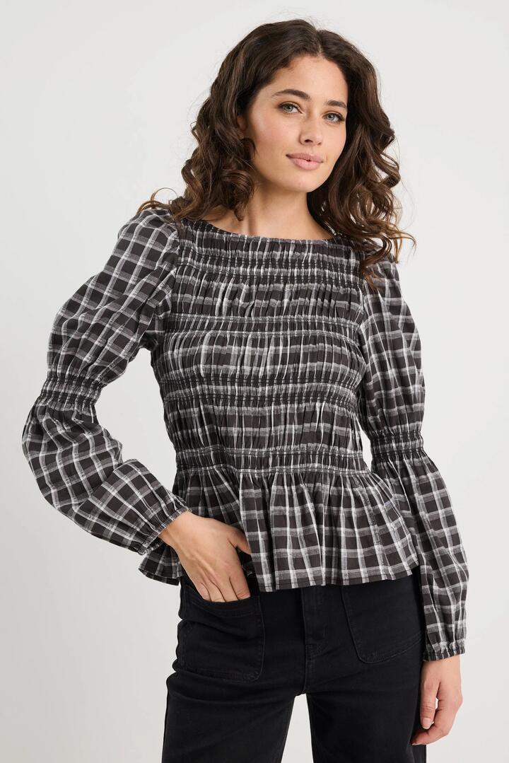 Image of a model wearing Tops. Product name - Required Black White Check LS Shirred Bodice Top in Black White Check colour by brand - Among the Brave