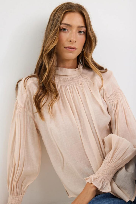 Image of a model wearing Tops. Product name - Adapt Vanilla Shirred LS Top in Vanilla colour by brand - Among the Brave