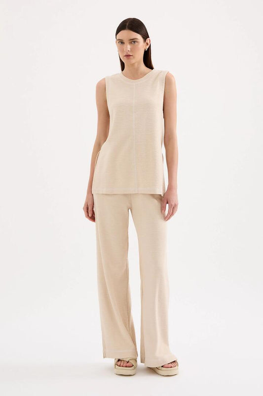 Image of a model wearing Pants. Product name - Sutton Cream Cotton Pant in Cream colour by brand - Nude Lucy
