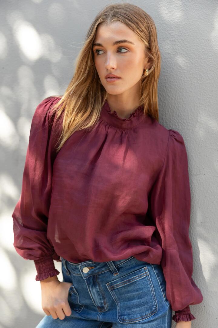 Image of a model wearing Tops. Product name - Poet Burgundy Plum Sheer Long Sleeve High Neck Top in Burgundy Plum colour by brand - By Rosa.